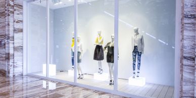 Mannequins displayed in a fashion store window.