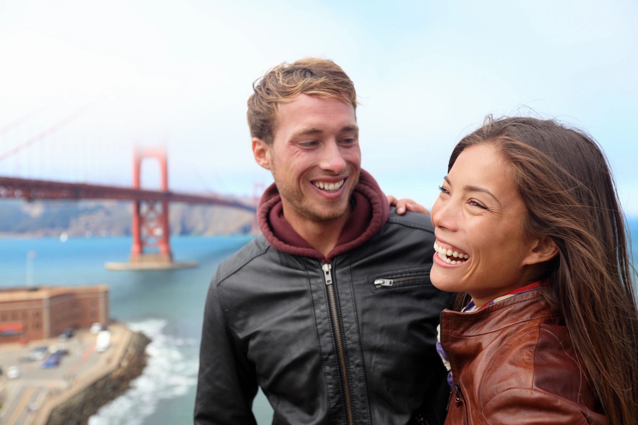 A guy and girl with golden gate bridge looking where to buy CBD in San Francisco, CA