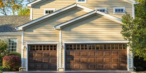 Amarr Brand Woodgrain garage doors with windows.