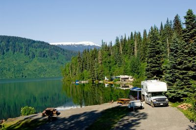 Outdoor view of lake with snow capped mountains in the distance