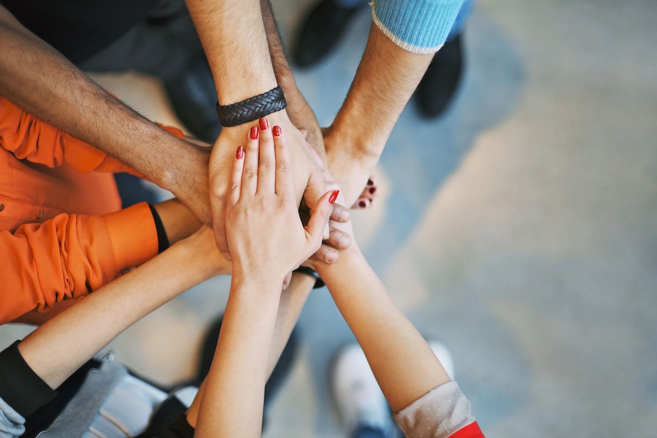 Team members place the hands in to display team buy-in to their goals together.