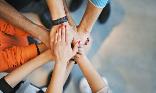 Group of hands from each family member coming together