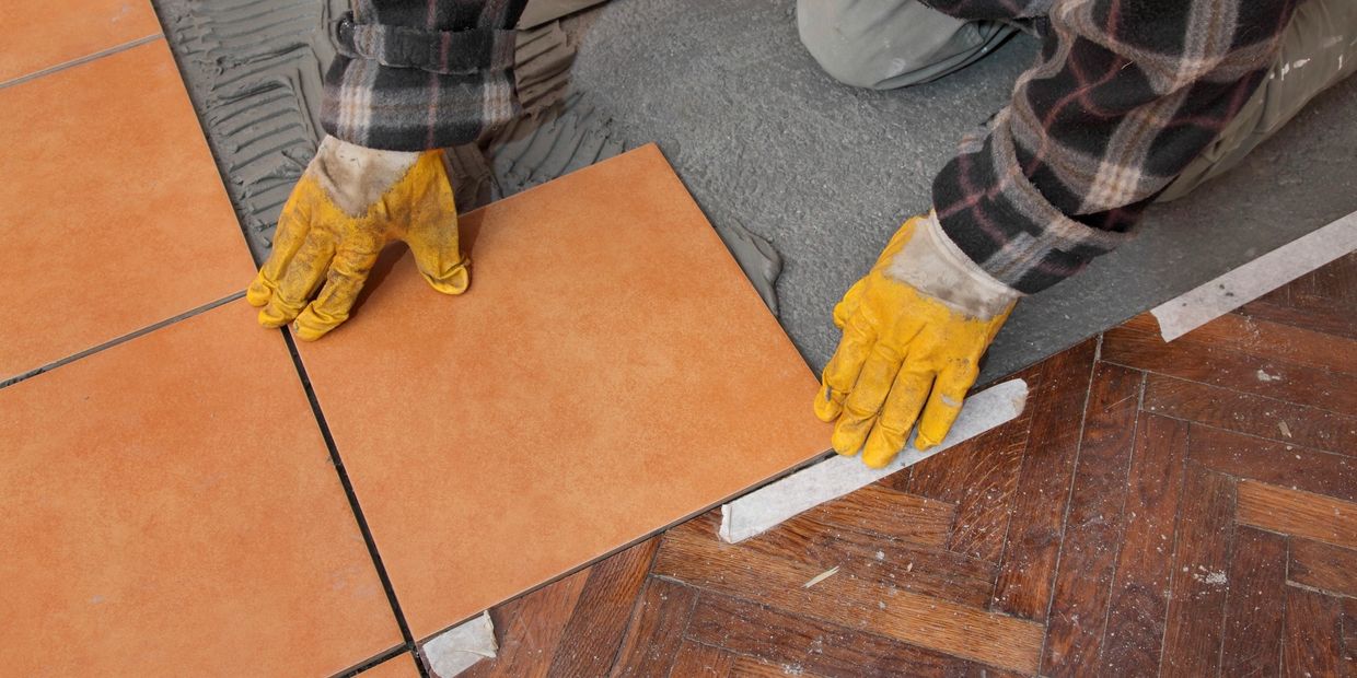 Worker installing tile floor