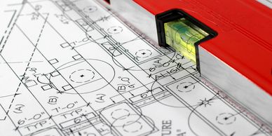 Fire Suppression Building & Fire Code Consulting Plans. on table with leveling tool