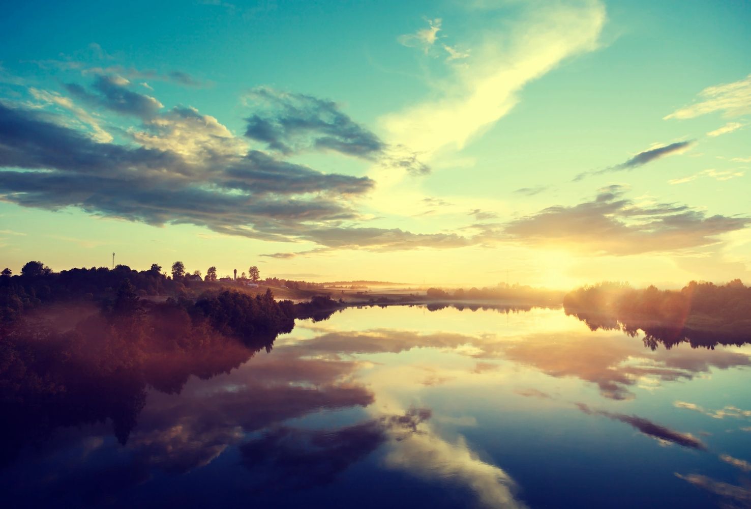 Clouds reflecting on a river with a blue sky and purple and 