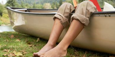 canoe with feet hangin over the edge