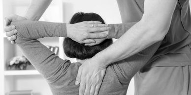 chiropractor performing an upper back adjustment 