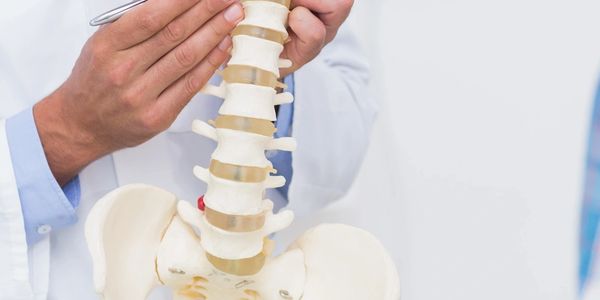 A man demonstrating the work of a chiropractor in the Mayodan and Madison, NC, area