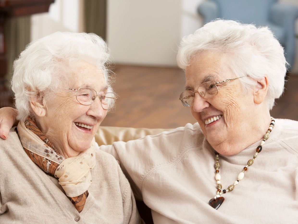 Elderly sisters laughing Meadows Assisted Living