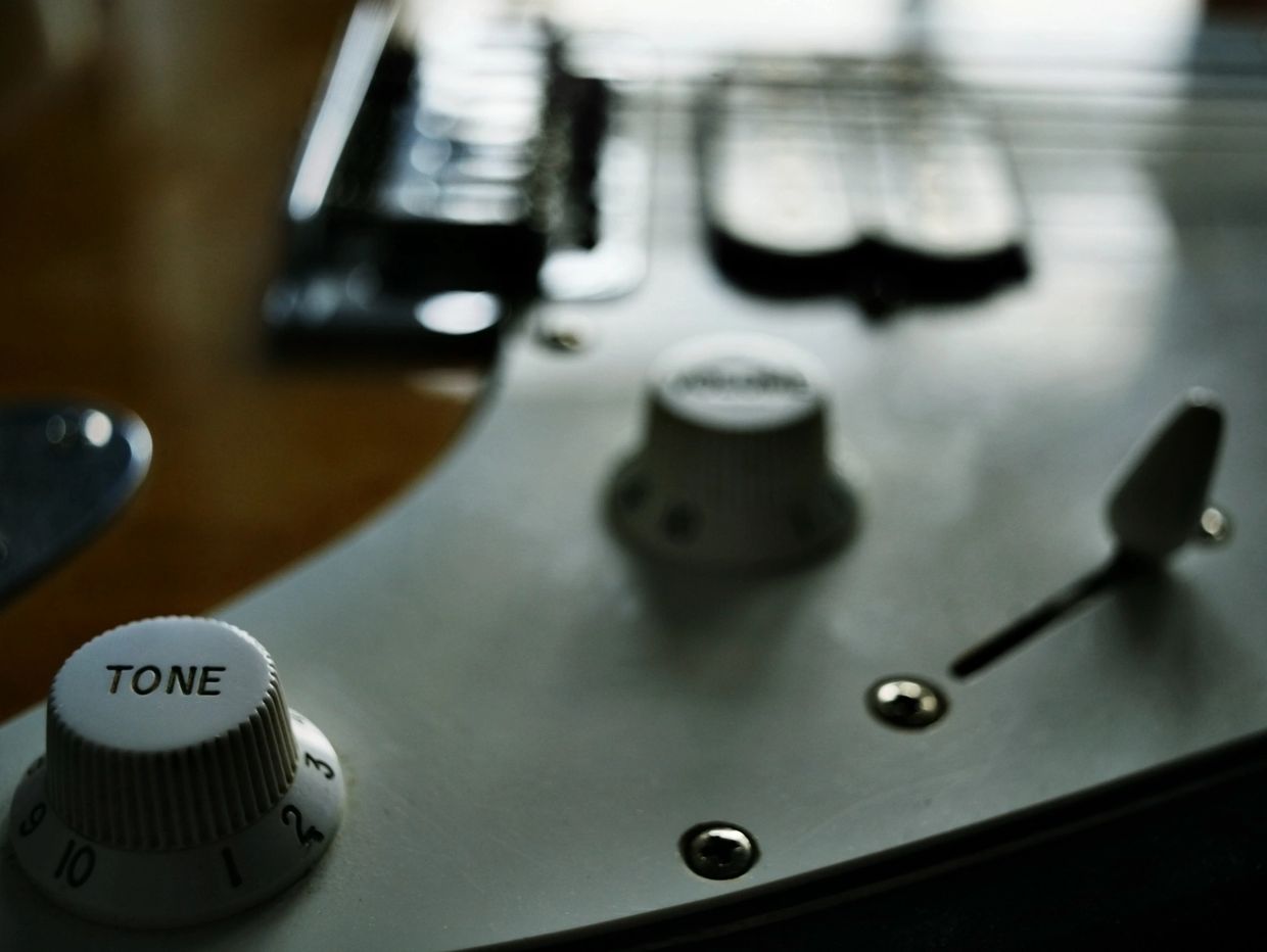 Close-up of a guitar's tone control knob.
