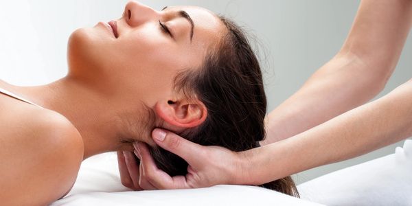 Woman receiving neck massage relaxation.