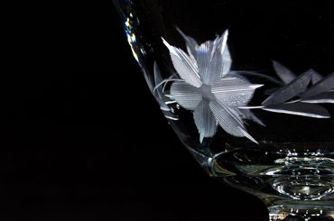 A picture of etched flower on a wine glass.