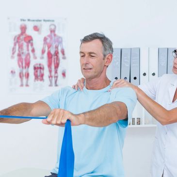 A female doctor helping a man with physiotherapy 