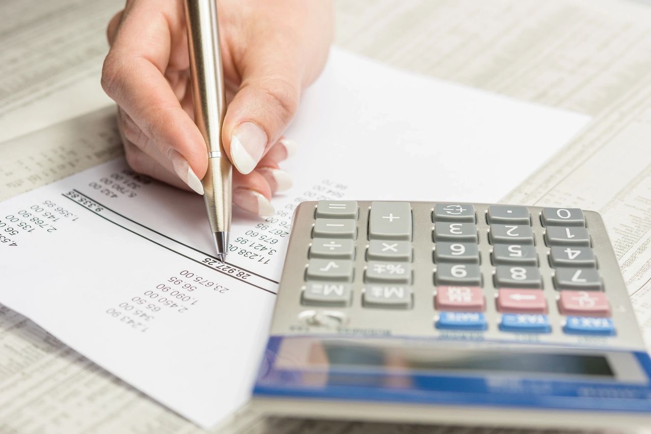 A person reviews the financial reports of their renovation project.