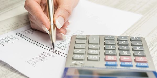 person checking figures with a calculator