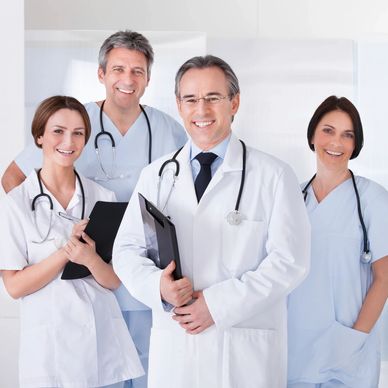 Group of four smiling medical professionals.
