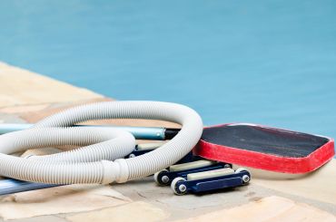 Pool cleaning equipment by the poolside.