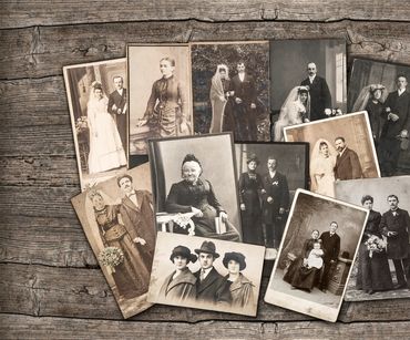 A collection of vintage black-and-white and sepia wedding photos on a wooden surface.