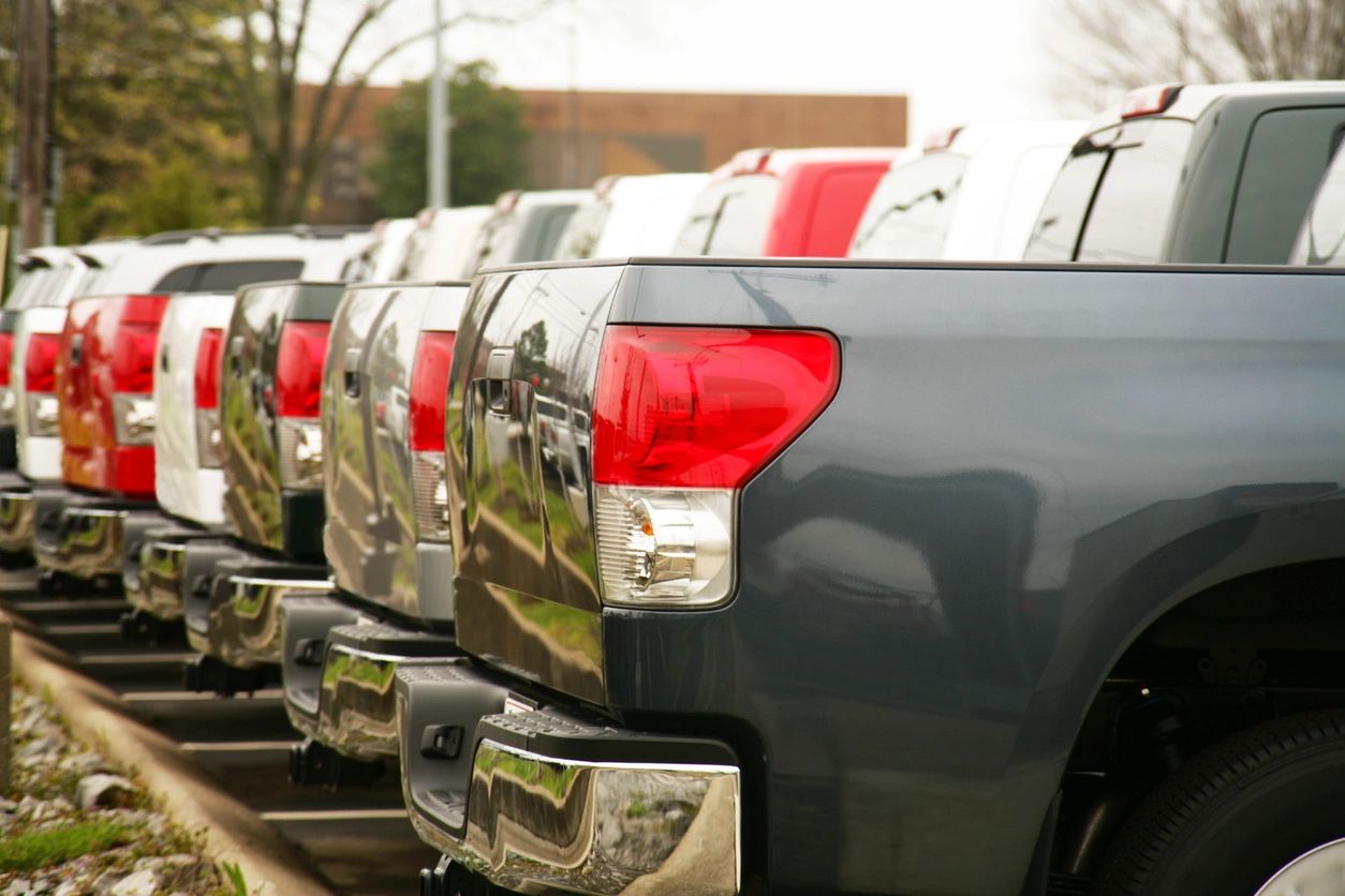 Pick up trucks from all manufacturers are lined up to be shipped to dealerships.