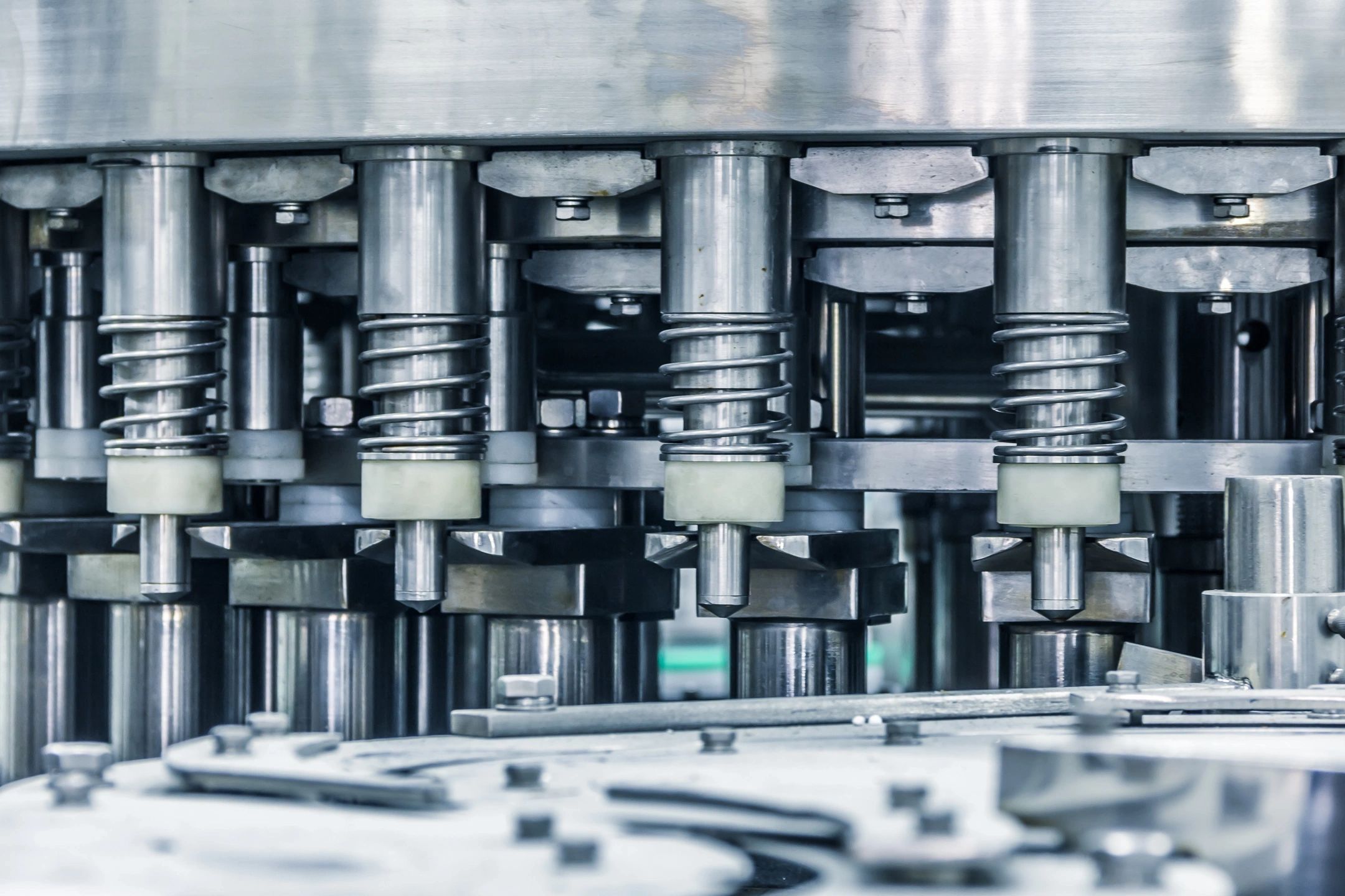 Close-up of industrial metal machinery with springs and bolts.