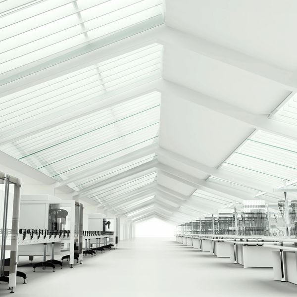 Bright, spacious modern laboratory with glass ceiling panels and clean white design.