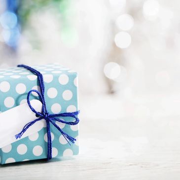A gift package with a blue cord and a white label