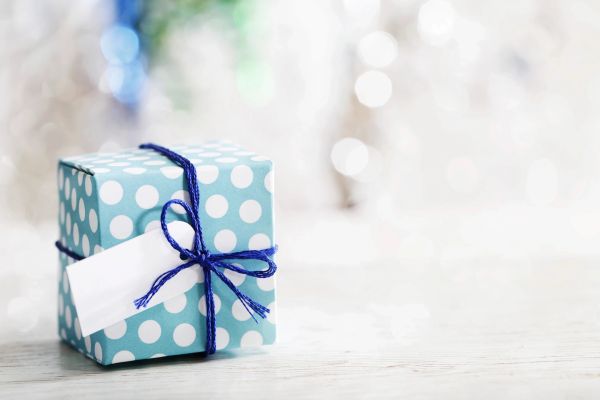 Blue polka dot gift box tied with a blue string bow.