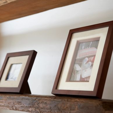 A shelf containing two photo frames of varying sizes