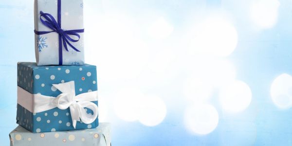 Stack of blue wrapped gifts with ribbons.