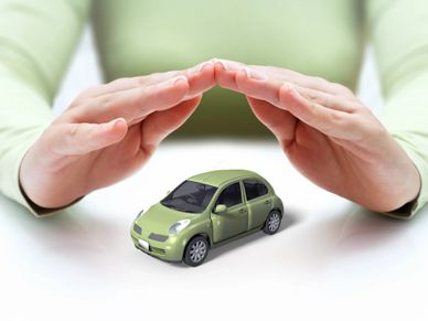 Hands protecting a toy car