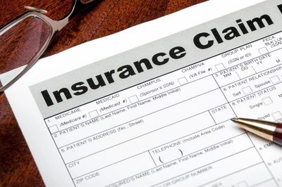 Close-up of an insurance claim form with a pen on it.