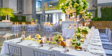 Wedding dinner party table setting with large flower centerpieces