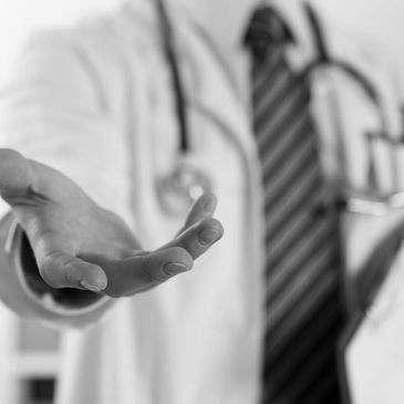 Doctor extending a hand in a gesture of help and care.