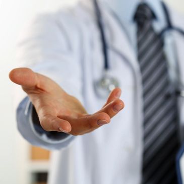 Doctor extending hand forward in a welcoming gesture.