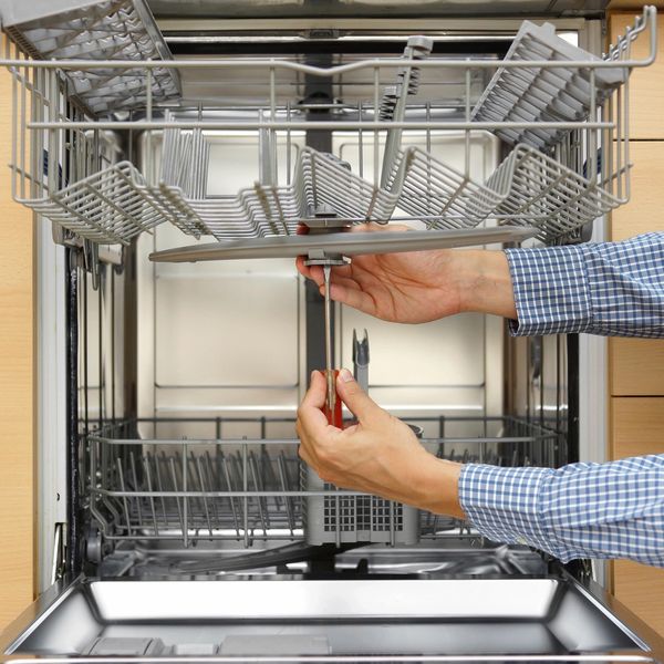 Technician Fixing Dishwasher