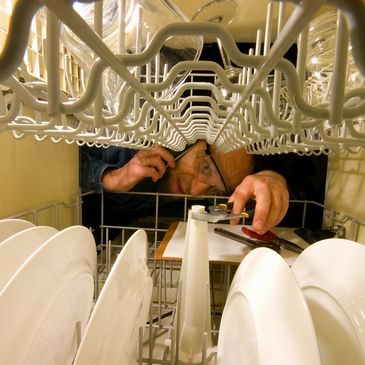 Repair man fixing dishwasher in Perth Region