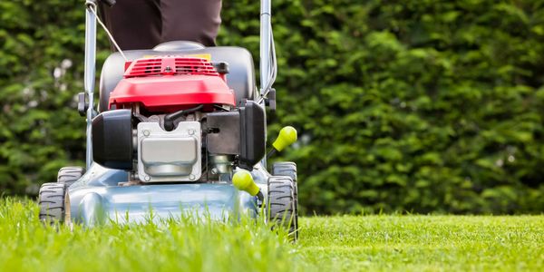 Unrecognizable Municipal Operator Mowing Grass Automatic Stock