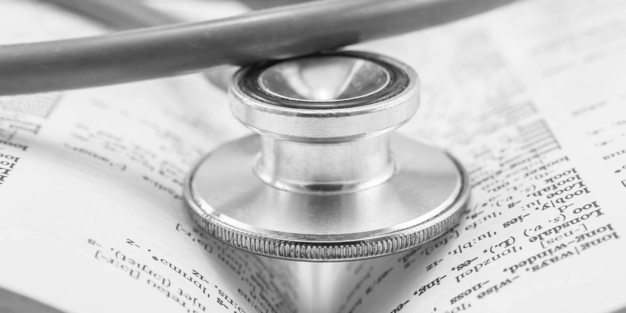 Stethoscope on an open medical book.