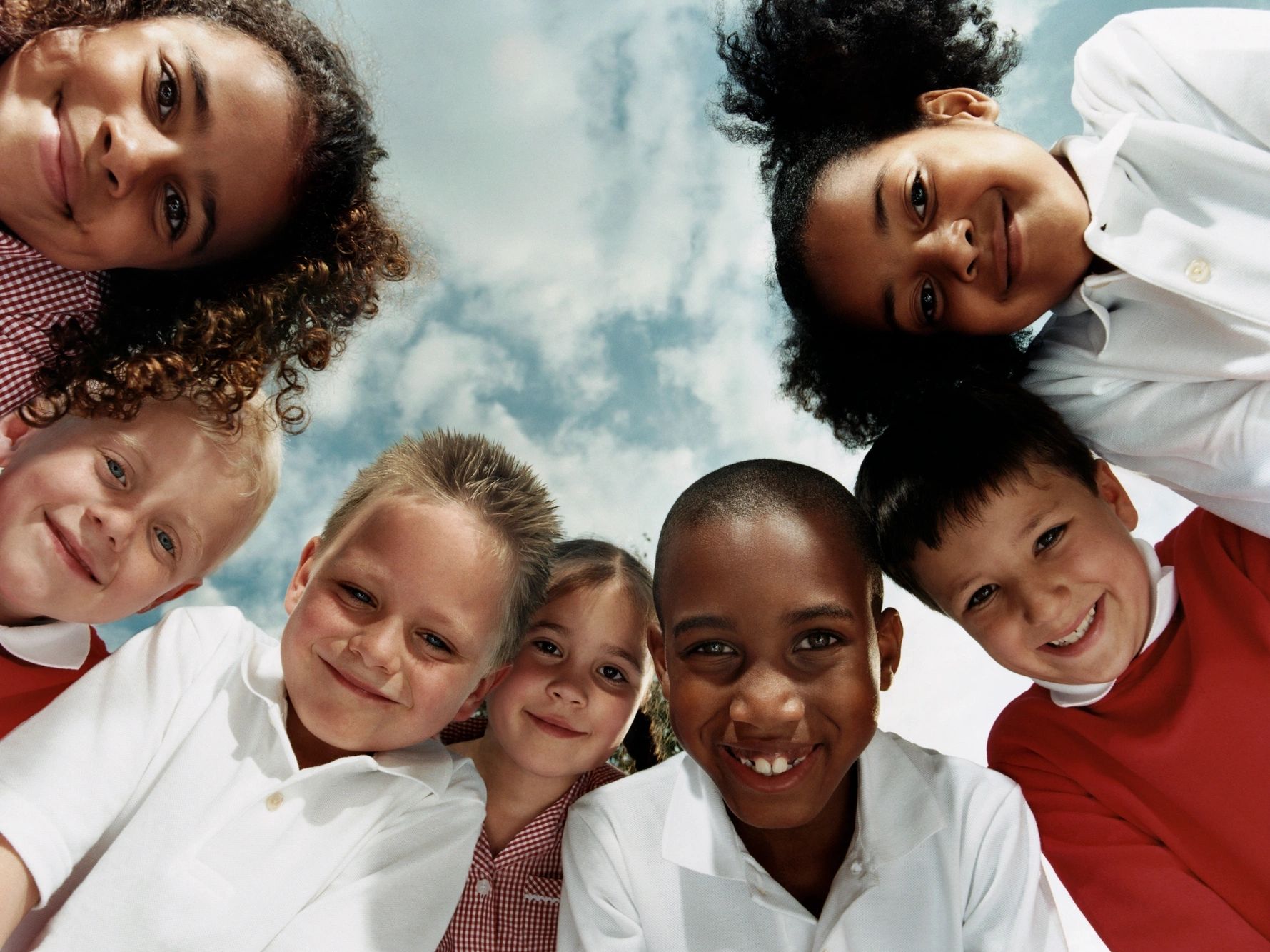 kids looking down forming a circle