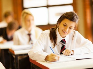 a class of students doing something in their notebooks
