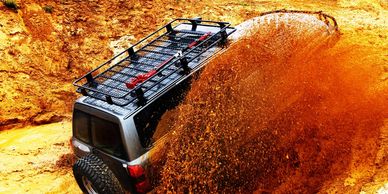 An Off Road car going through mud