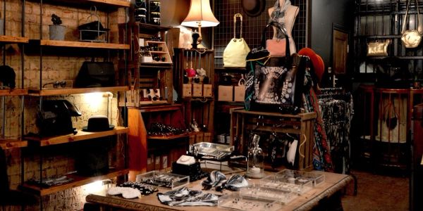 Cozy vintage boutique with accessories and warm lighting.