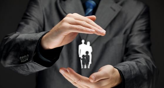 Man with cupped hands holding a silhouette of a family