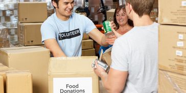 Volunteers sorting canned food for donations.