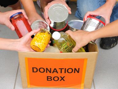Photo of a donation box for 'Harrow Food Bank'.