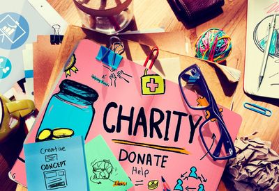 Colorful charity donation campaign materials on a cluttered desk.