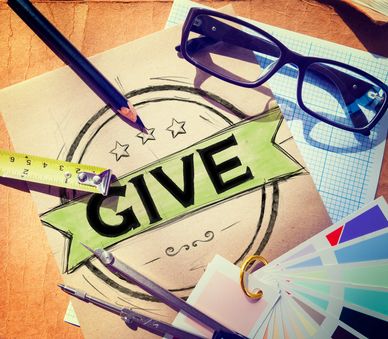 Creative workspace with the word GIVE.