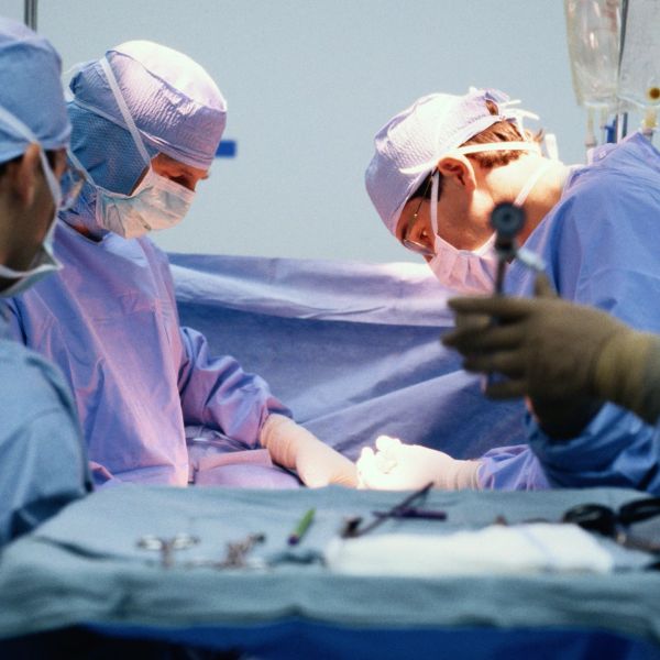 Surgeons performing surgery in a sterile operating room.
