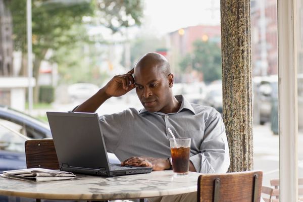 A man using his laptop outdoors