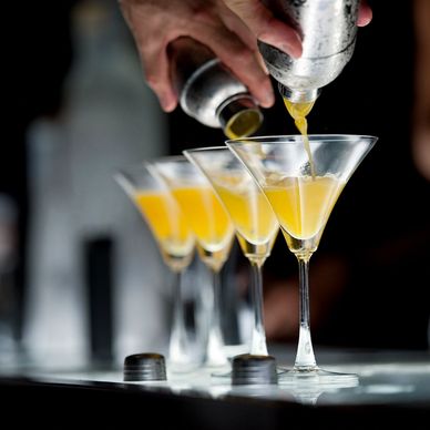 Pouring Alcohol into Martini Glasses